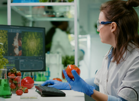 pharmaceutical-chemist-examining-tomato-microbiology-experiment-typing-medical-information